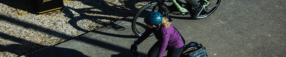 Orbea hybrid bikes being ridden in a park my mana and women